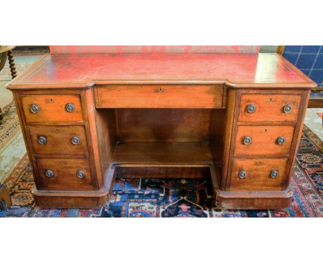 KNEEHOLE DESK, 75cm H x 142cm W x 55cm D, Victorian mahogany, circa 1870, with red leather top above seven drawers, on cerami
