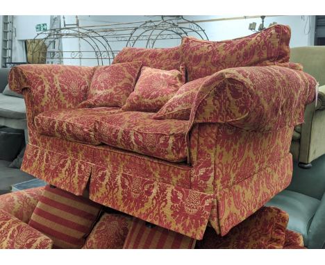 DURESTA SOFA, two seater, in red and gold foliage pattern upholstery, with scatter cushions, 70cm H x 190cm W, 105cm D. 