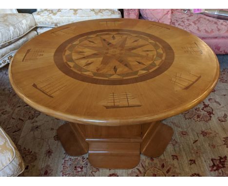 LOW YACHT TABLE, 53cm H x 109cm, fruitwood and marquetry with circular nautical compass inlaid top and cupboard door below. 