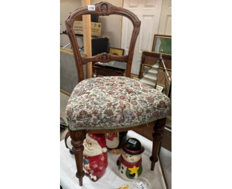 An Edwardian carved mahogany chair with tapestry top