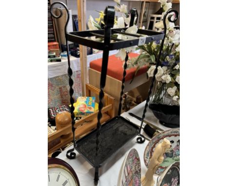 A wrought iron umbrella/ walking stick stand