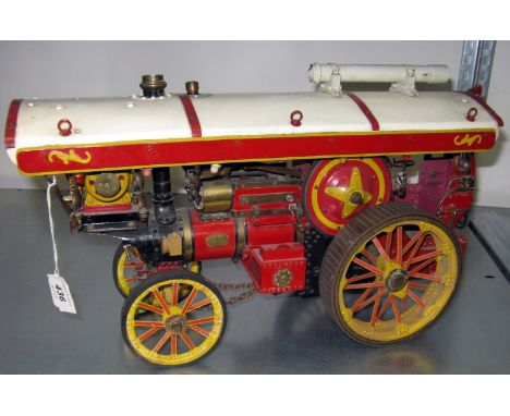 A 1 inch Scale live steam deep Red Burrell Showman's Engine with a Tin Canopy on spiralled Columns and metal Yellow spoked wh