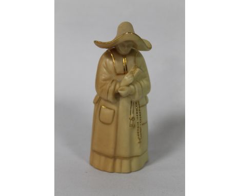 A ROYAL WORCESTER BLUSH IVORY CANDLE SNUFFER in the form of a nun, puce factory mark, H 9.5 cm