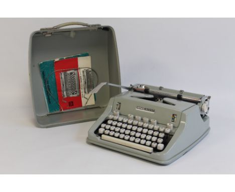 A VINTAGE HERMES 3000 TYPEWRITER, with instruction paperwork in grey carry case
