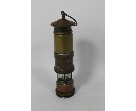 A SMALL HOME MADE MODEL OF A MINERS LAMP, with coin top and bottom. Height 13 cm