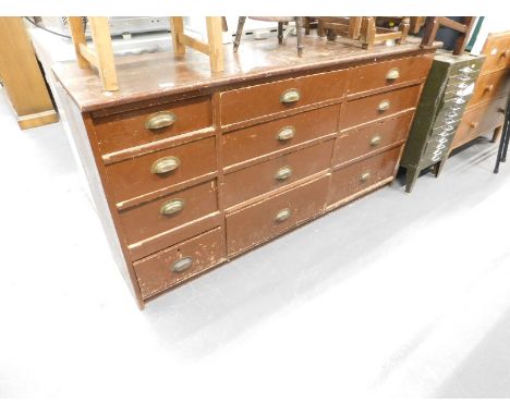 A 19thC pine tool cabinet of rectangular form set with three banks of four drawers, containing a quantity of watch making ite