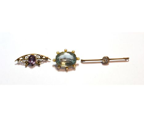 An aquamarine and seed pearl brooch, length 3.5cm; an amethyst and seed pearl brooch, stamped '9CT', length 4.7cm; and anothe
