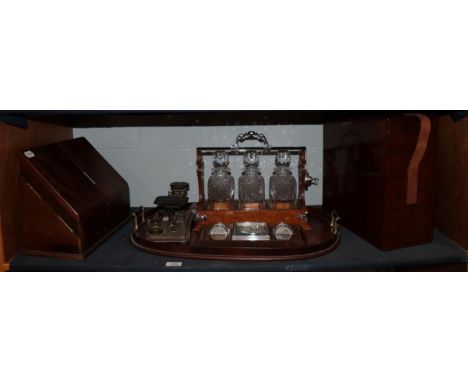An Edwardian mahogany and satinwood inlaid twin-handled tray; a pair of postal scales and weights; a three decanter tantalus;