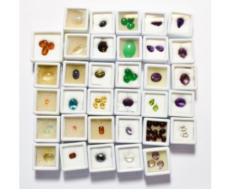 A quantity of loose gemstones including amethyst, peridot, garnet, rock crystal, haematite, jade, smoky quartz, citrine, hess