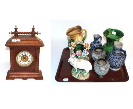 An oak cased Ansonia striking mantel clock; green glaze Toby jug; a pair of squat vases initialled and incised E.W, E.H; two 