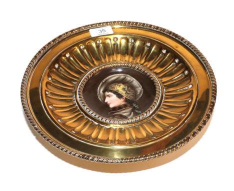 A late 19th/early 20th century brass comport with a circular porcelain panel 