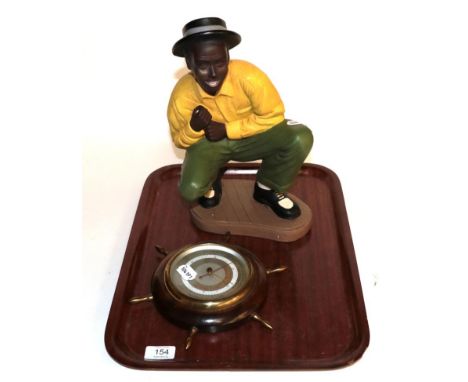 A 1930s oak striking mantel clock; a later barometer; and a novelty figure 