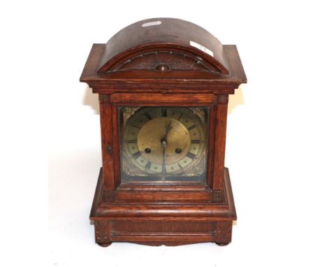 An oak cased striking mantel clock with brass dial, circa 1900