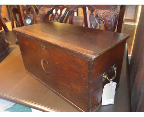A 19th century oak trunk, painted with a 'C', with brass handles 