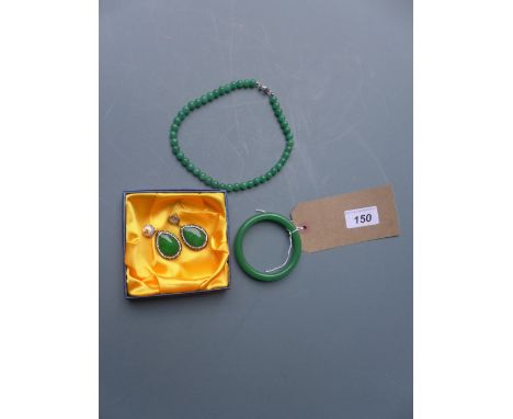 A Chinese jade bangle together with matching earrings and beaded necklace 