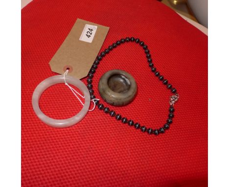A Chinese jade bangle, together with a jade water pot and a banded agate necklace 