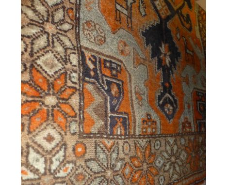 A Persian rug having central medallion on an orange field with zoomorphic designs together with an Oriental carpet having flo