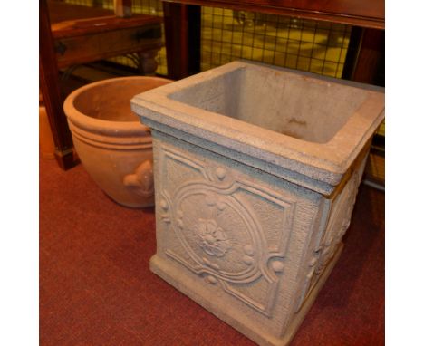 A terracotta planter and another planter 