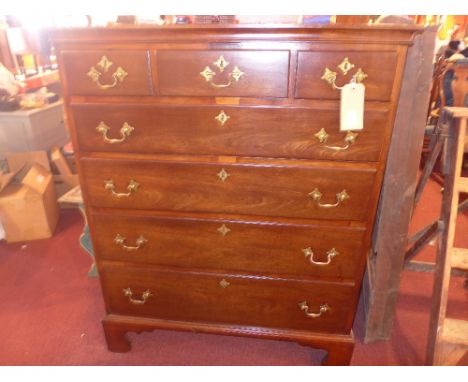 A Georgian mahogany tall chest of three short over four long graduated drawers with brass handles raised on bracket supports 