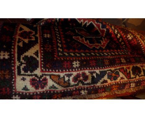 A fine south west Persian Qashqai carpet 302cm x 217cm triple pole medallion with repeating petal motifs on a terracotta fiel