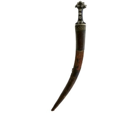 A LARGE WAHABITE JAMBIYA, 55cm sharply curved blade, characteristic white metal mounted hilt, the shaped wooden grip applied 