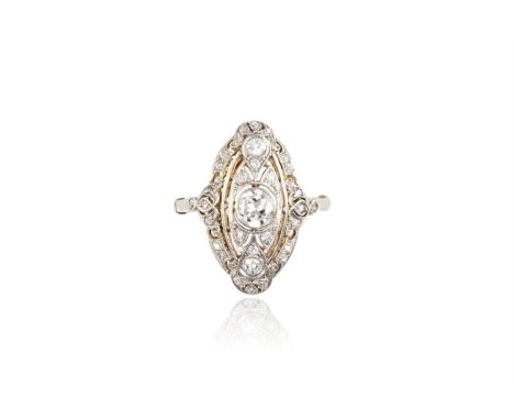 A BELLE EPOQUE DIAMOND RING, CIRCA 1910The finely pierced and slightly domed navette-shaped plaque, centrally-set with a tran