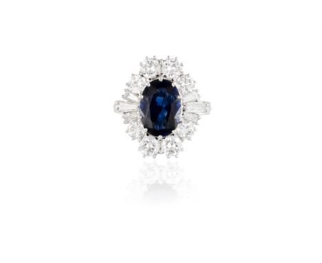 A SAPPHIRE AND DIAMOND CLUSTER RINGThe oval-shaped sapphire, weighing approximately 3.20cts, within a surround of brilliant a