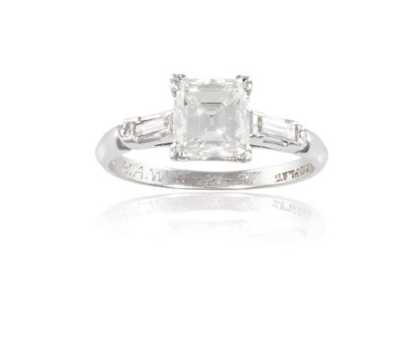 A DIAMOND SINGLE-STONE RINGThe square step-cut diamond, weighing approximately 1.10cts, between two baguette-cut diamond shou