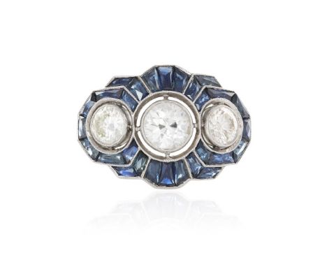 AN ART DECO DIAMOND AND SAPPHIRE DRESS RINGOf stylised scalloped form, set centrally with an old brilliant-cut diamond, weigh