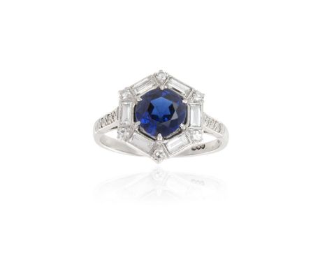 AN ART DECO SAPPHIRE AND DIAMOND RINGThe round-shaped sapphire, weighing approximately 1.50cts, within a hexagon-shaped frame