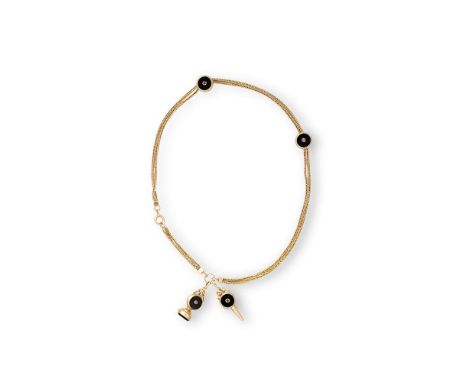 A CONTINENTAL GOLD, ONYX AND RUBY WATCH CHAINTwo strand curb chain with two onyx and ruby links and fob, with matching windin