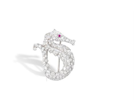 A DIAMOND AND RUBY SEAHORSE BROOCH, CIRCA 1935The body set with brilliant and single-cut diamonds, highlighted by a similarly