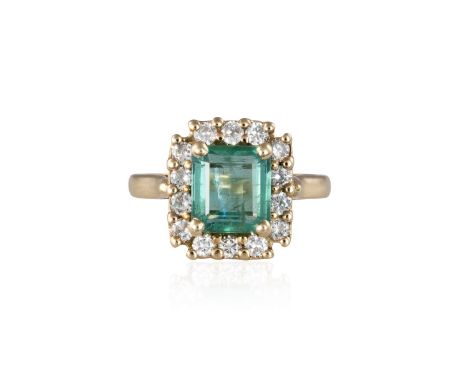 AN EMERALD AND DIAMOND CLUSTER RINGThe rectangular-cut emerald, weighing approximately 2.00cts, within a surround of round br