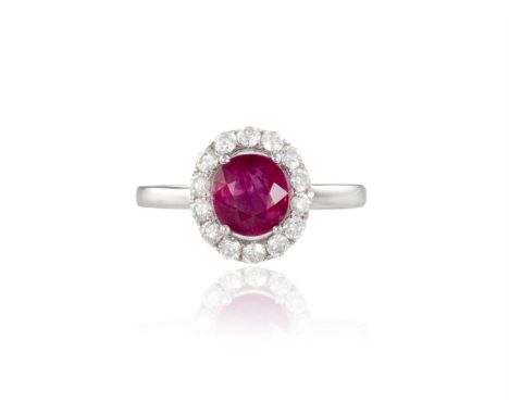 A RUBY AND DIAMOND CLUSTER RINGThe round-shaped ruby, weighing 1.69cts, within a surround of round brilliant-cut diamonds, mo