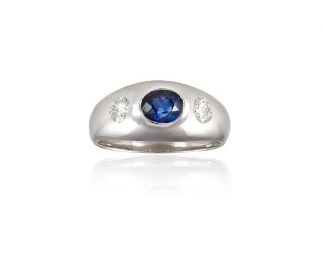 A SAPPHIRE AND DIAMOND THREE-STONE RINGThe bombé band centrally set with an oval-shaped sapphire, between two gypsy-set brill