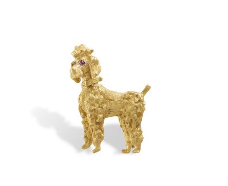 A GOLD NOVELTY 'DOG' BROOCHThe standing poodle with textured fur and cabochon ruby eyes, mounted in 18K gold, maker's marks, 