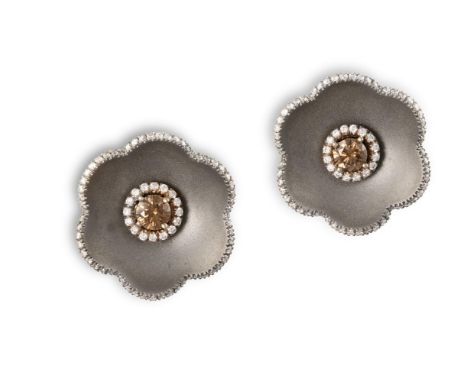 A PAIR OF DIAMOND AND TITANIUM EARRINGS, BY MARGHERITA BURGENEREach titanium flowerhead centrally highlighted by a round bril