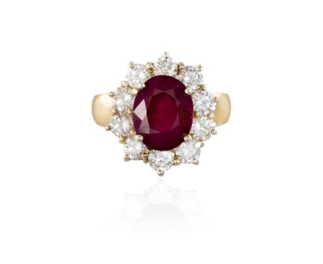 A RUBY AND DIAMOND CLUSTER RINGThe oval-shaped ruby, weighing approximately 4.66cts, within a surround of round brilliant-cut