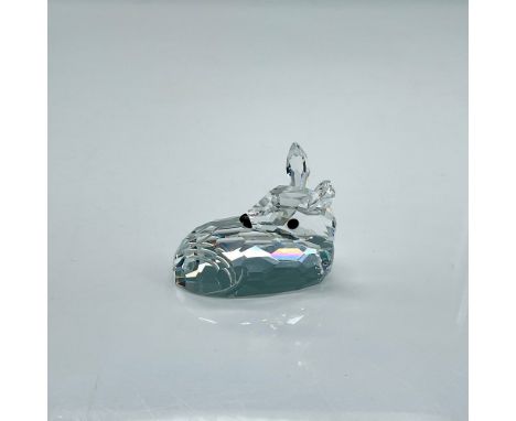 Clear faceted crystal figure of a resting baby deer with black eyes and nose. Swarovski mark. Part of the Woodland Friends co