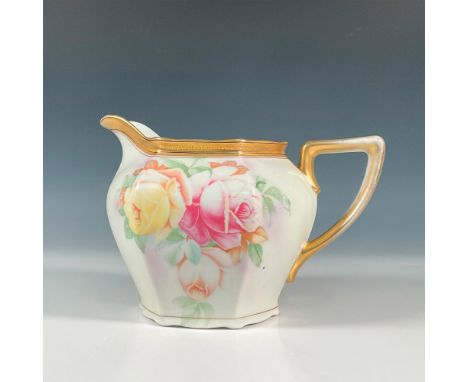 A large hand painted pitcher designed with roses on each side with further gilt detailed along the border and handle. J S V G