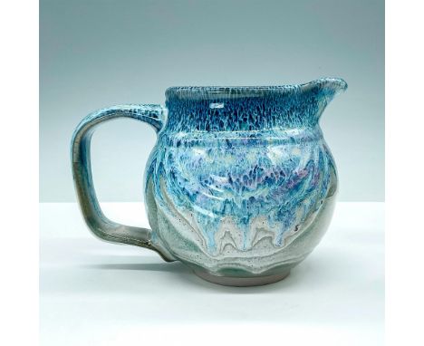 Beautiful hand-crafted pitcher with stunning blue and grey glaze finish. Bay stamped to base. Dimensions: 7.25"L x 5"W x 5"HC