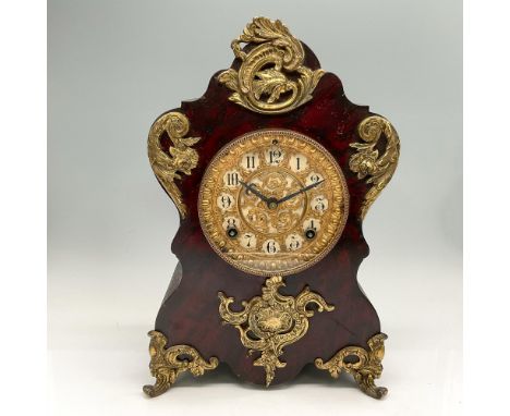 Black enameled iron case in late baroque style, decorated with applied gilt brass acanthus ornaments. The round Brass dial be