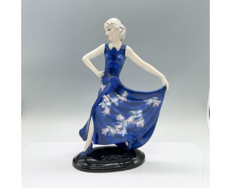 An Art Deco dancer in a long blue floral dress. Goldscheider marked. Model 7454. Artist name under the base. Artist: Josef Lo