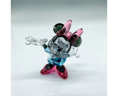 Faceted and smooth crystal figure of Minnie Mouse standing with her arms open. Pink shoes and bow; blue dress. Part of the Mi