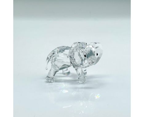 Clear faceted crystal figure of an elephant with black eyes, his trunk to the side. Part of the Rare Encounters collection. S