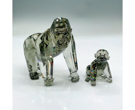 Two sparkling black diamond crystal figures, mother gorilla and her young one. Swarovski etched mark. Signed by artist. Mothe