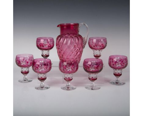 Lively cranberry and clear glass pitcher and seven drinking glasses with etched design of flowers and grapes. Pitcher is 7"L 