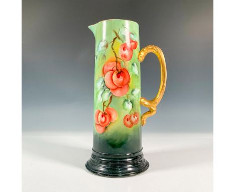 A beautiful tall pitcher with a gilded handle. The jug is decorated with painted red cherries and a gilded trim. Jean Pouyat 