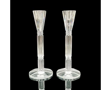 A set of 2 slender, clear, candlestick stands with round bases and vertical cuts with horizontal notches. Dimensions: 3.25"W 