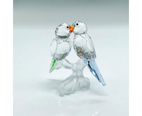 Clear faceted crystal figural of two budgies perched on a frosted base. One has light blue tail feathers, the other light gre